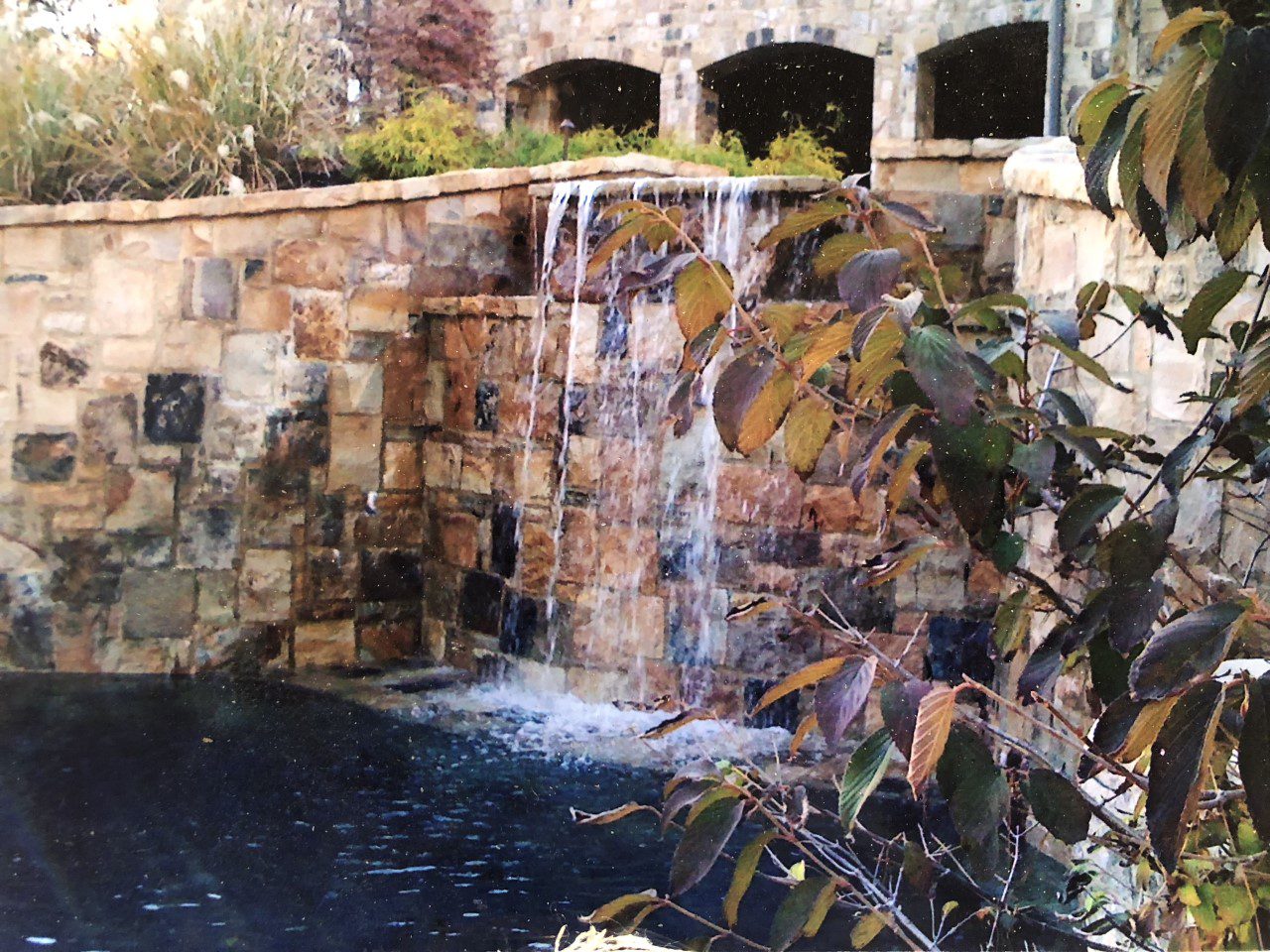 A pool with a man-made waterfall